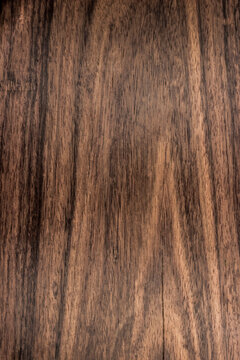 background is made of old wood. an old board. the texture of a rustic table. african blackwood, grenadil, Dalbergia, a place for a text or object. view from above. the effect of aging, vertical
