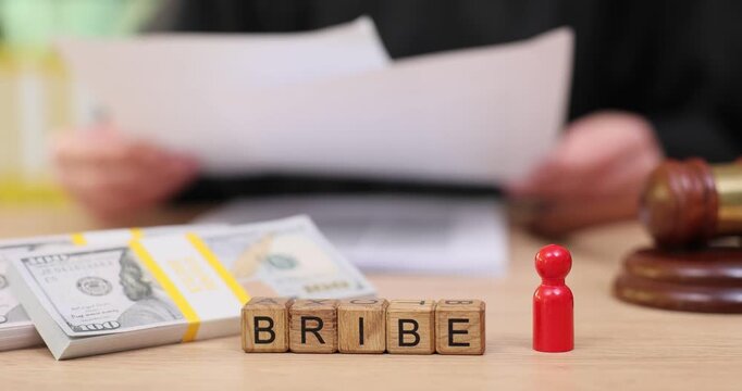 Holding a court document while bribe money waits unseen in a courtroom setting