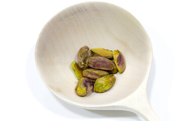 Heap of tasty pistachio nuts isolated on white background