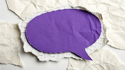 A digital illustration of a purple speech bubble with textured, torn paper effect.