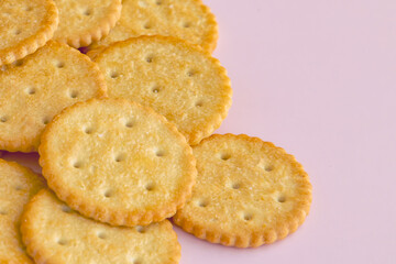 Delicate fresh crackers on a light purple background close-up. Photo for cracker packaging, fresh cookies
