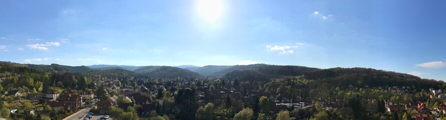 Panoramic view of a small town with hill and forest landscapes