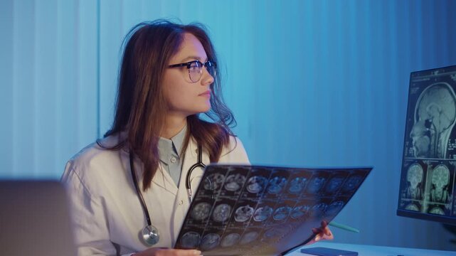 Scientific Breakthrough. Female Doctor Holds Brain MRI Scans While Presenting New Neurology And Stroke Research, Highlighting Medical Discoveries Innovative Diagnostics, And Progress In Modern Science