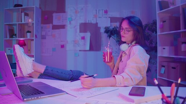 Remote Learning, Creative Focus, Gen Z Style. Student Works on Homework in Neon Room, Sketching by Laptop at Night. Calm Moment of Study, Visual Thinking, and Personal Expression