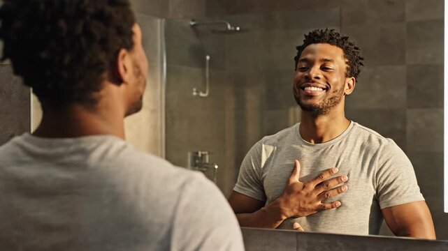 Confident Man Affirming Himself in the Mirror with a Smile.