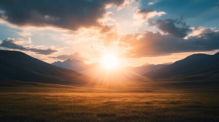 Golden sunset over a vast valley with mountains.