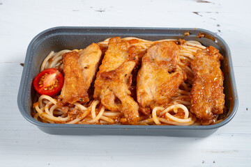 angle view box of pan-seared chicken breast with spaghetti at horizontal composition