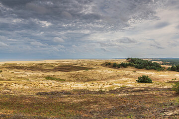 The image depicts a scenic view of a vast area of sand dunes