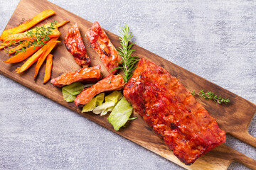 Roasted rack of pork ribs and sweet potato fries. View from above, top studio shot
