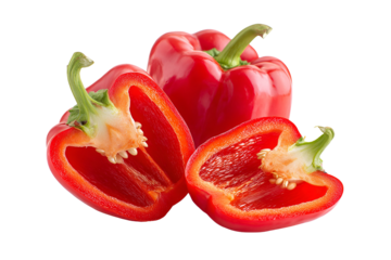 Vibrant red bell peppers freshly cut and isolated on a black background