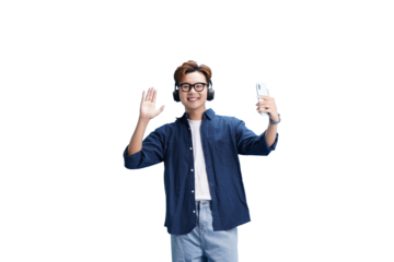Modern Selfie with Headphones: A young, stylish individual, sporting headphones and glasses, joyfully captures a selfie on their phone, waving at the camera with a warm smile.