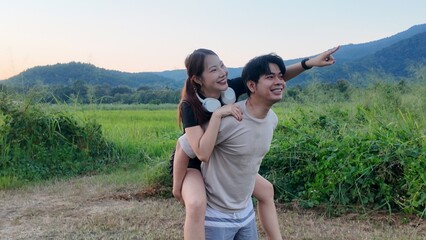 A man and a woman are standing in a field