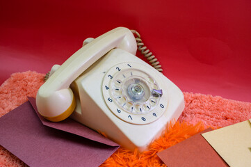 red phone on old wooden table