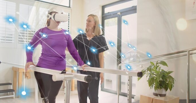 Gripping bars patient wearing VR headset receiving therapist aid in rehab with network overlay