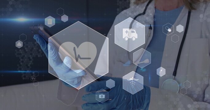 Holding tablet, doctor wearing lab coat with stethoscope, gloves using medical icons in clinic
