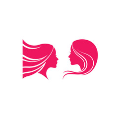 Elegant pink silhouettes of two women facing each other with flowing hair vector