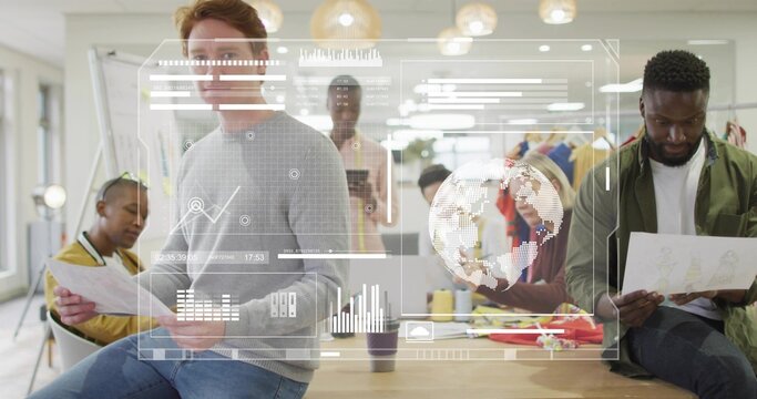 Gathering design team reviewing charts, data overlays on wooden table in design studio, with tablet