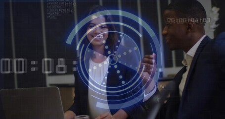 Reviewing sales data, executives collaborating at office desk in suits with laptop, HUD overlay