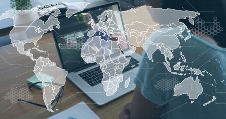 Sitting man wearing blue-shirt videocalling in-office with laptop under map-overlay, copy space