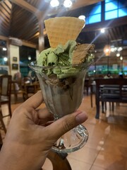 Woman holds a gelato in her left hand