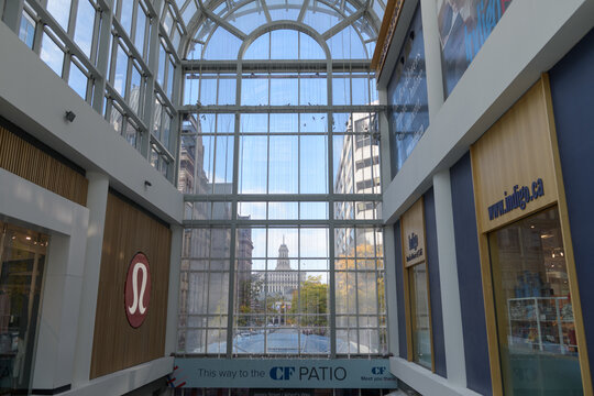 view west from inside CF Toronto Eaton Centre including lululemon and Indigo shop signs, Albert St entrance