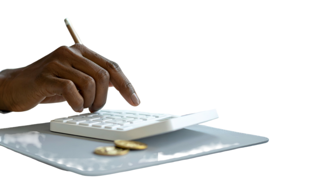 A dark-skinned hand uses a calculator with two coins on a surface, on a black backdrop