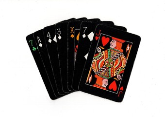 Obraz premium A hand of vintage playing cards isolated on a white background.