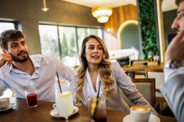 Friends enjoying drinks at fancy restaurant