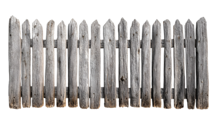 Rustic wooden fence with weathered planks and pointed tops against a dark background