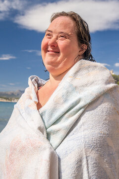 Woman with towel on beach representing inclusion