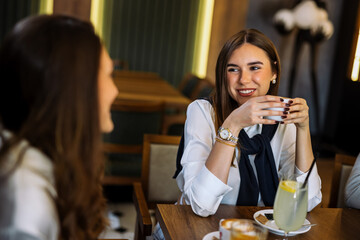 Friends enjoying drinks at fancy restaurant
