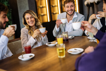 Friends enjoying drinks at fancy restaurant