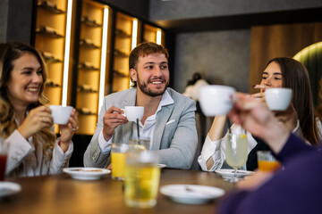 Friends enjoying drinks at fancy restaurant