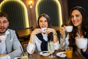 Friends enjoying drinks at fancy restaurant