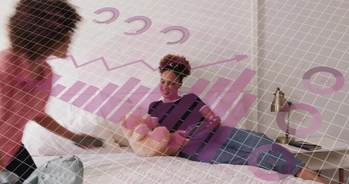 woman reclining on bed holding tablet, friend entering with tote rummaging for technology talk