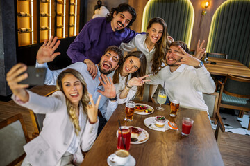 Friends taking selfie at cafe
