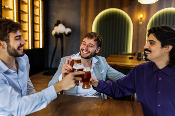 Three men cheering with beer
