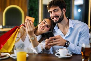Couple shopping online in restaurant