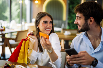 Couple shopping online in restaurant