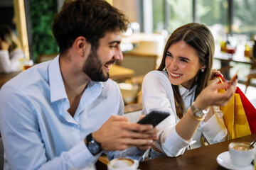 Couple shopping online in restaurant
