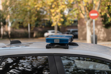 Blue emergency light on patrol car roof is flashing in the city street © Jorge