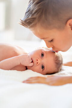 Tender sibling bond captured in gentle kiss