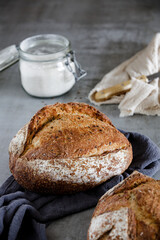 Freshly Baked Artisan Bread on Wooden Board in Rustic Kitchen Setting