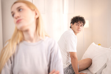 A husband and wife with their bitter feelings towards each other on bed