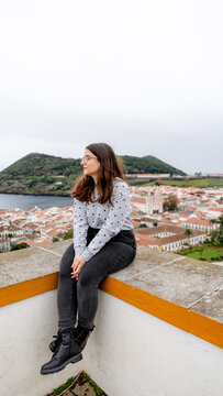 Woman sitting at viewpoint of historic obelisk