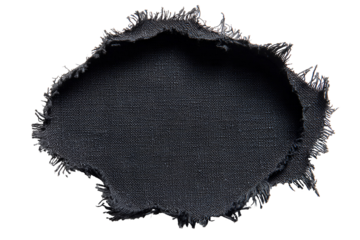 Close up macro shot of a torn dark fabric with frayed edges against a black background