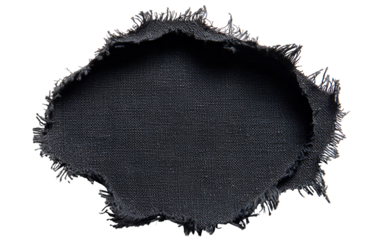 Close up macro shot of a torn dark fabric with frayed edges against a black background