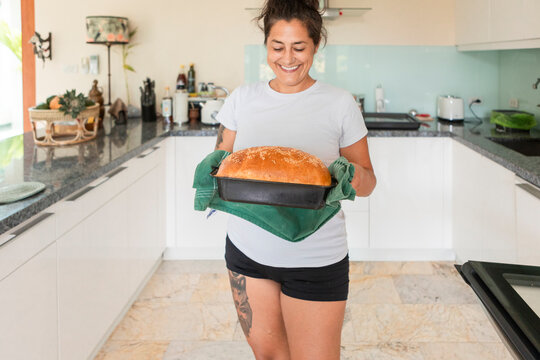 Woman baking fresh homemade bread in the kitchen