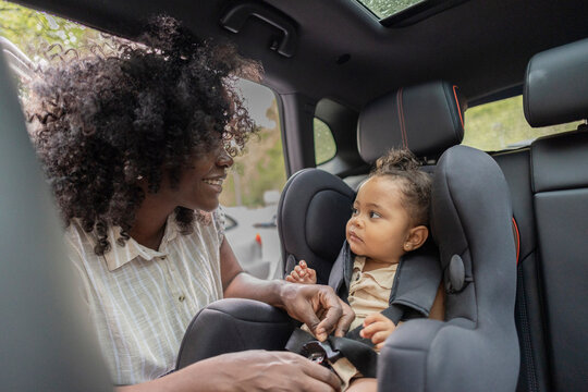 African American mother and daughter bonding in car