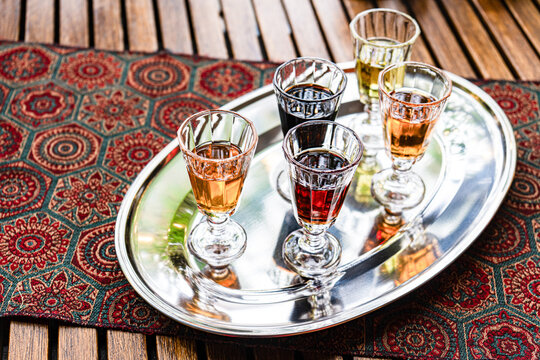 Assorted vodka varieties on a silver tray with tapestry